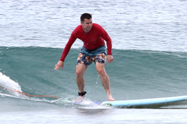 a man riding a wave on a surfboard in the water